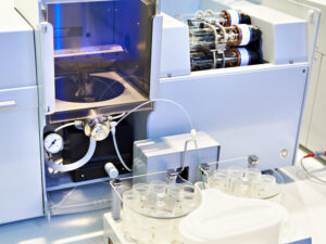 absorption spectrometer with autosampler tray of sample vials in a laboratory absorption spectrometer with autosampler tray of sample vials in a laboratory